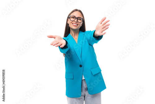 young pretty office worker woman in a blue business jacket looks successful and happy on a white background with copy space