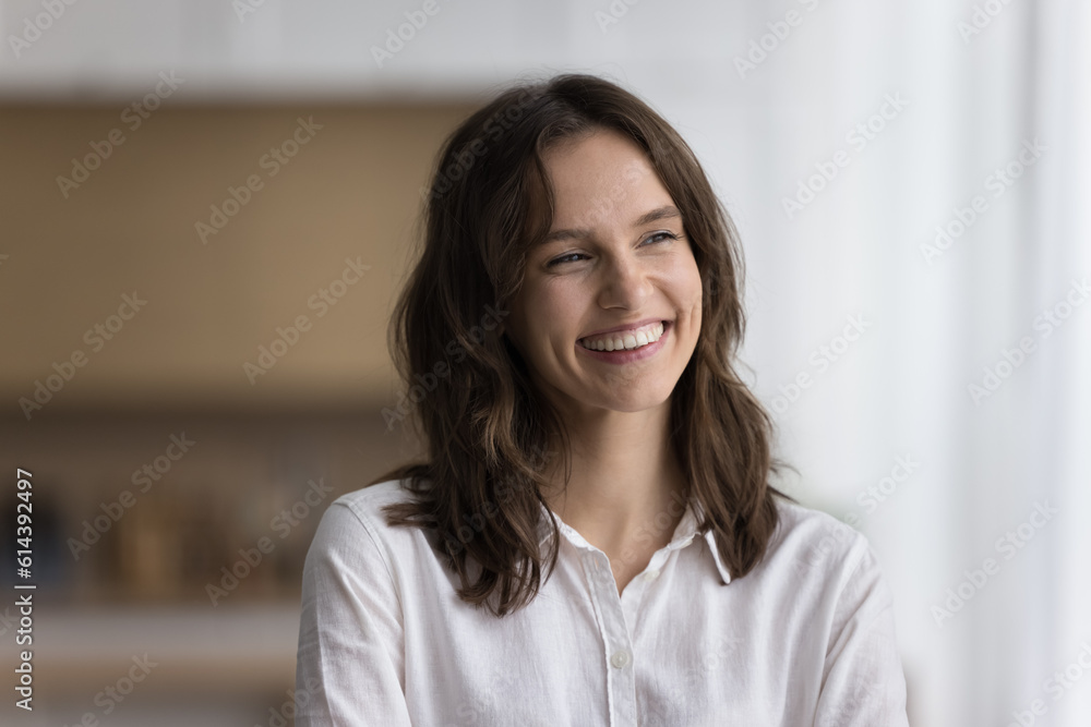 Head shot of beautiful calm woman standing alone in kitchen smile looking aside enjoy daydreaming on weekend at own or rented house. Millennial generation person portrait, happy mood and aspirations Head shot of beautiful calm woman standing alone in kitchen smile looking aside enjoy daydreaming on weekend at own or rented house. Millennial generation person portrait, happy mood and aspirations