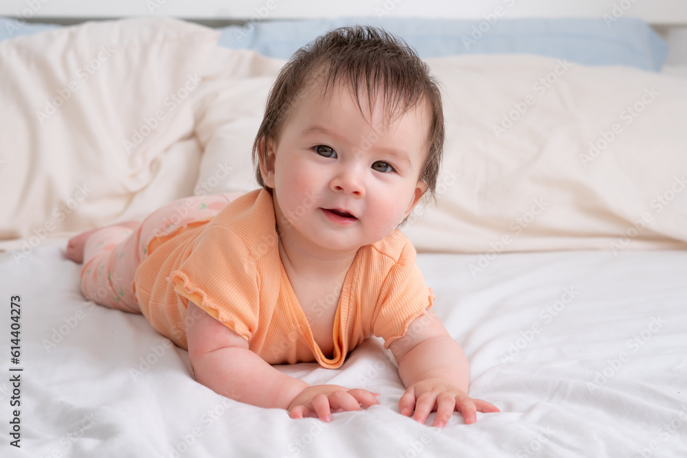 lifestyle home portrait of happy and beautiful 8 months old baby girl mixed race Asian Caucasian playing cheerful on bed exploring the surroundings curious lifestyle home portrait of happy and beautiful 8 months old baby girl mixed race Asian Caucasian playing cheerful on bed exploring the surroundings curious