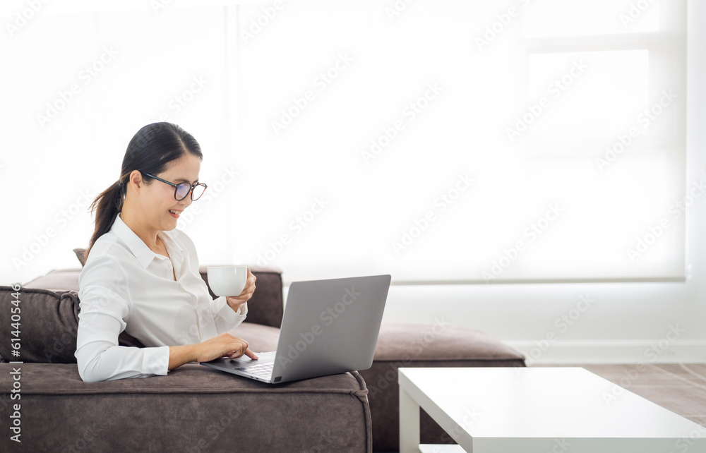 asian mature woman working on laptop in living room at home office. asian professor using computer remote teaching , virtual training, e-learning, watching online education webinar at home asian mature woman working on laptop in living room at home office. asian professor using computer remote teaching , virtual training, e-learning, watching online education webinar at home