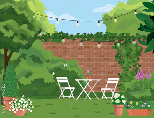 Back patio with garden furniture on a background of green plants.