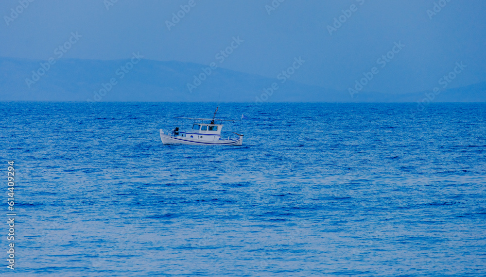Small fishing boat sailing in Mediterranean sea