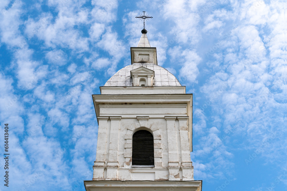 Tower of high white church on the sky background