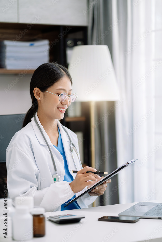 female medical doctor's hands write a note and use tablet working. Doctor's working place. Healthcare and medical concept. female medical doctor's hands write a note and use tablet working. Doctor's working place. Healthcare and medical concept.