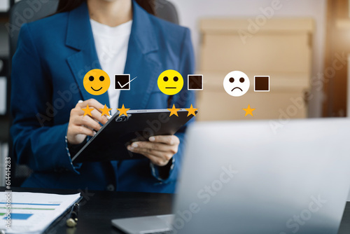 Woman holding a digital tablet and smartphone with checkboxes rating smiley faces excellent for Satisfaction Survey, Happy Client Customer Experience concept.
