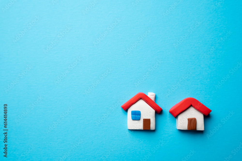 Houses on a blue background. Place for text. Find most suitable housing options. Offers on real estate market. Mortgage. Valuation of residential buildings. Realtor services. Buying and selling. Houses on a blue background. Place for text. Find most suitable housing options. Offers on real estate market. Mortgage. Valuation of residential buildings. Realtor services. Buying and selling.