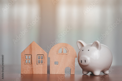 Piggy bank with wooden hous...