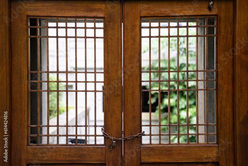 Wooden doors and windows are chained and locked with keys