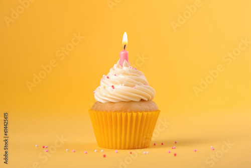 Tasty birthday cupcake with a candle on a yellow background. Mini cake. Ai generative.