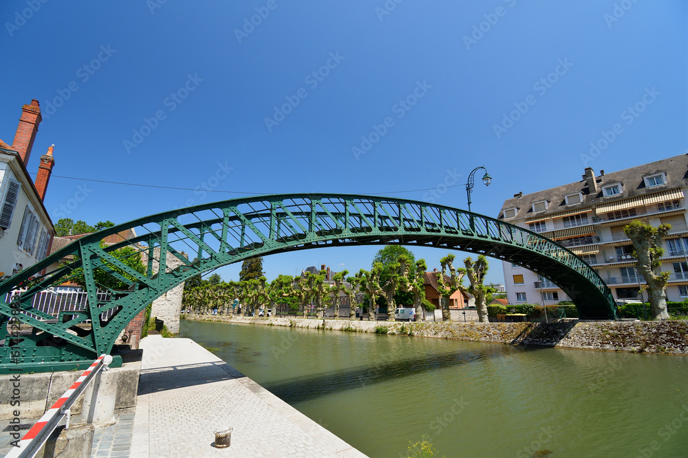 Fototapeta premium France, Montargis. Cityscape with a canal. May 29, 2023.
