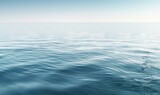  a large body of water with a blue sky in the background and some waves in the foreground and a light blue sky in the background.  generative ai