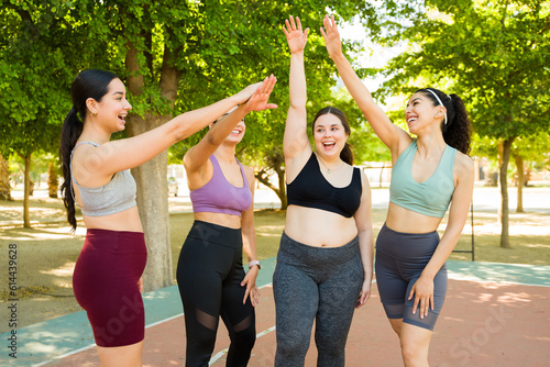 Excited diverse group of women promoting body acceptance in fitness