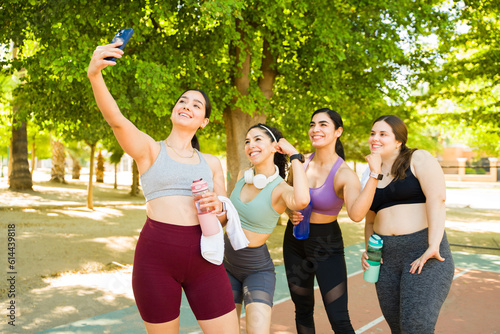 Attractive group of diverse women taking a selfie after exercising