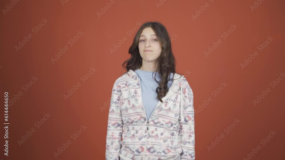 Young woman looking at camera with a negative expression. Young woman looking at camera with a negative expression.