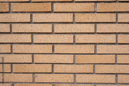 Background wall of yellow bricks closeup.