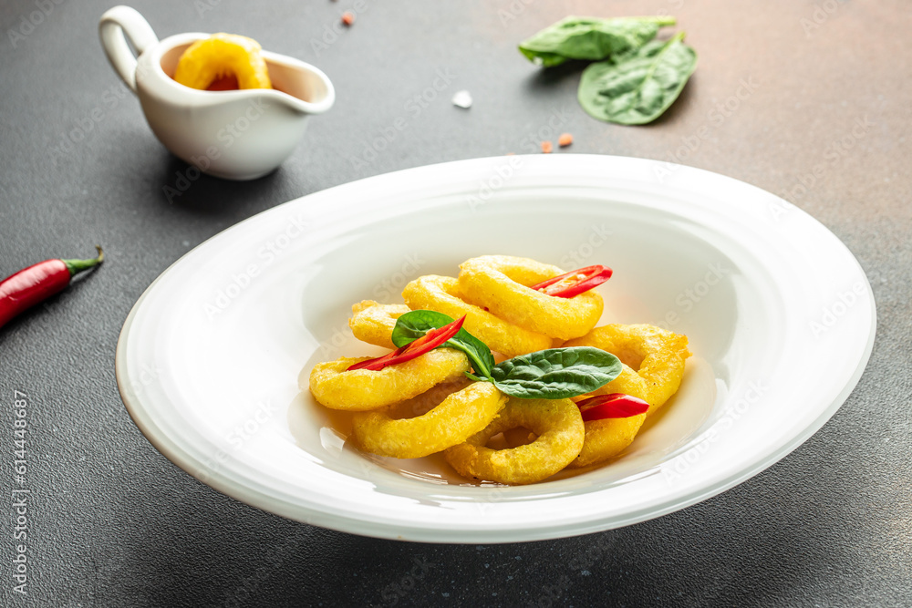 fried squid rings breaded on a dark background. banner, menu, recipe place for text, top view fried squid rings breaded on a dark background. banner, menu, recipe place for text, top view