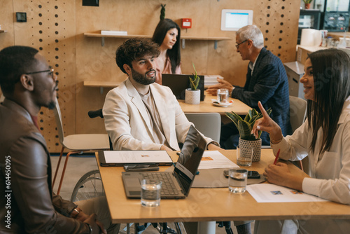 Fotografía Multiracial, inter-generational businesspeople working at modern co working space