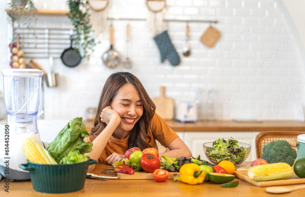Portrait of beauty body slim healthy asian woman having fun cooking and preparing cooking vegan food healthy eat with fresh vegetable salad on counter in kitchen at home.Diet concept.Fitness, healthy
