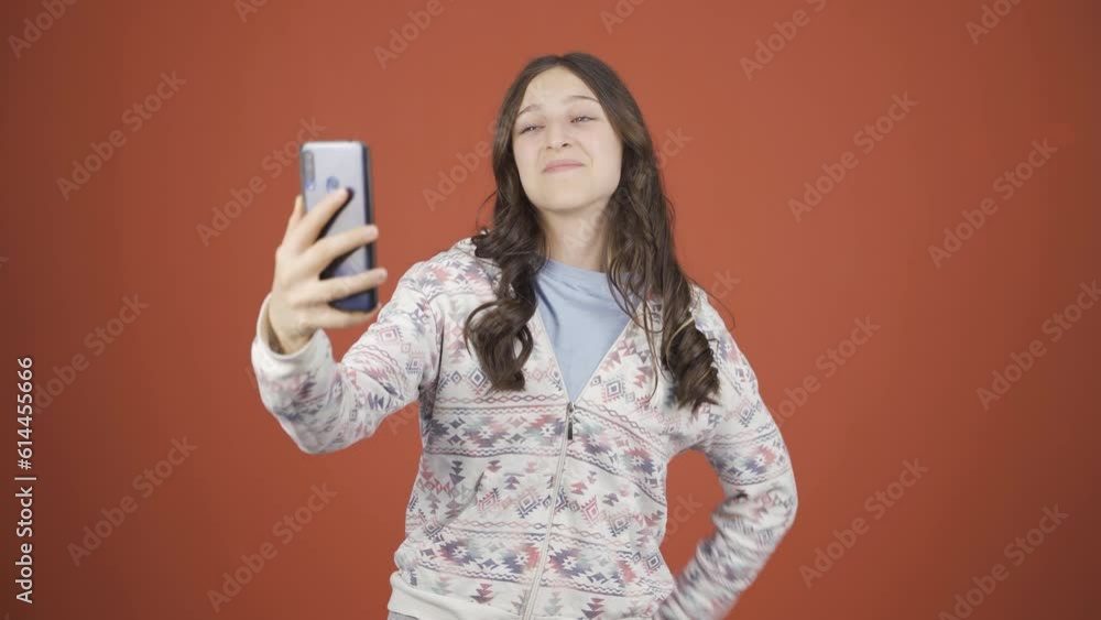 Young woman making a video call on the phone. Young woman making a video call on the phone.