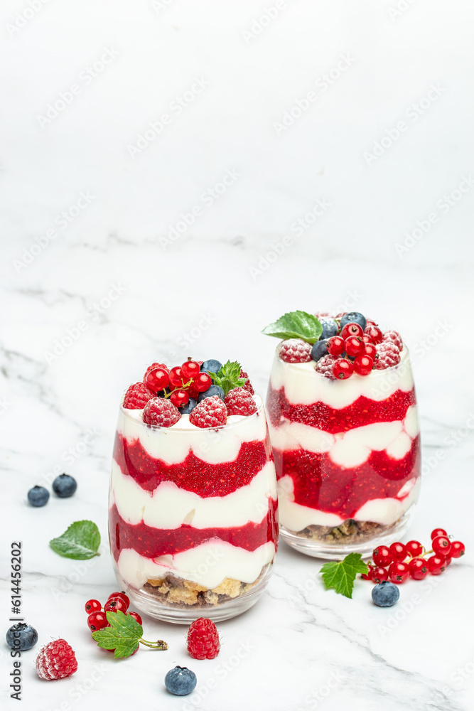 Cranachan raspberry dessert in jar on a light background. Restaurant menu, dieting, cookbook recipe top view Cranachan raspberry dessert in jar on a light background. Restaurant menu, dieting, cookbook recipe top view
