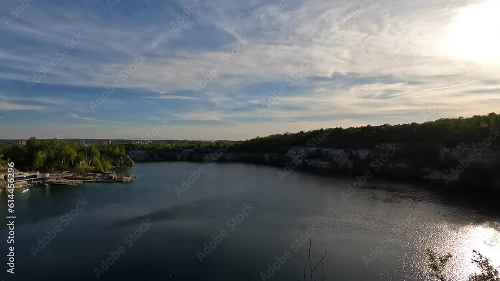A stunning 4k video of a large lake in the Zakrzowek park in Krakow. The lake is surrounded by cliffs and forests and has a clear turquoise water. perfect for nature and travel A stunning 4k video of a large lake in the Zakrzowek park in Krakow. The lake is surrounded by cliffs and forests and has a clear turquoise water. perfect for nature and travel