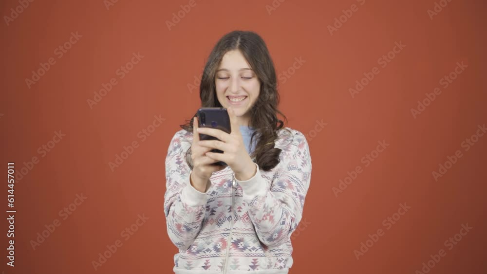 Happy young woman texting on the phone. Smiling. Happy young woman texting on the phone. Smiling.
