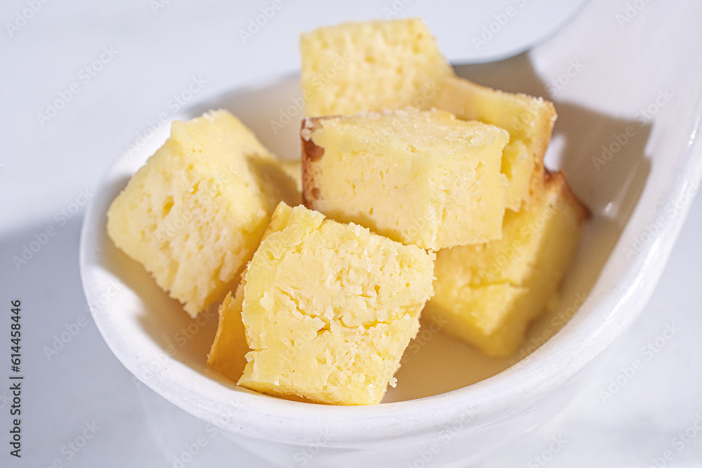 sliced butter cake on white plate .