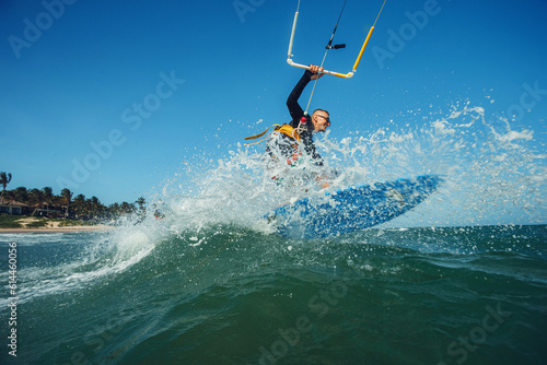 Kite surfer riding a kiteboard on the sea with splash © Oleg