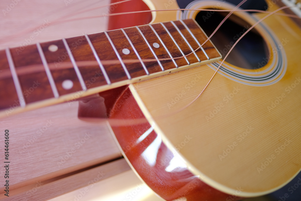 close up wooden part of the instrument changing strings on