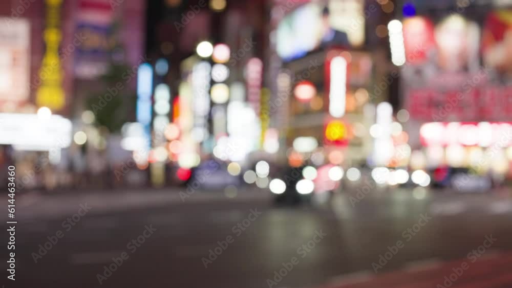 Slow motion of traffic in city nightlife at japan. Blurred focus. Boke of neon lighting and LED banner Slow motion of traffic in city nightlife at japan. Blurred focus. Boke of neon lighting and LED banner