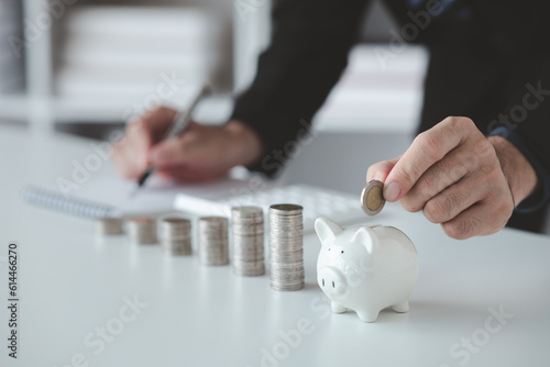 Person with pile of coins and piggy bank, money saving concept for future use and financial stability, salary management, personal finance, investment savings. photo