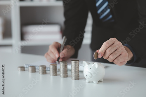 Person with pile of coins and piggy bank, money saving concept for future use and financial stability, salary management, personal finance, investment savings.