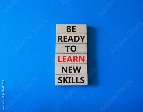 Learn new skills symbol. Concept words Be ready to Learn new skills on wooden blocks. Beautiful blue background. Business and Learn new skills concept. Copy space.