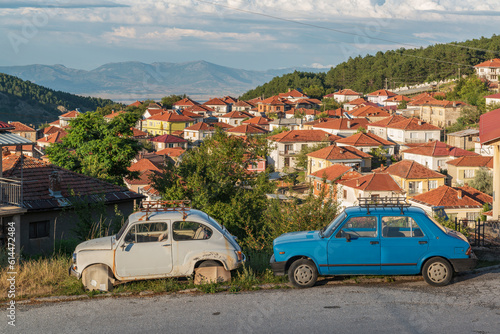 Old rusty retro cars on the street of old Balkan town.