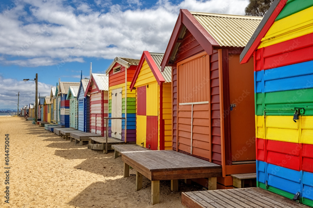 Fototapeta premium Brighton beach Victorian bathing boxes. Brightly painted colourful beach huts line the sand in Melbourne, Australia. They are highly desirable and extremely expensive real estate.
