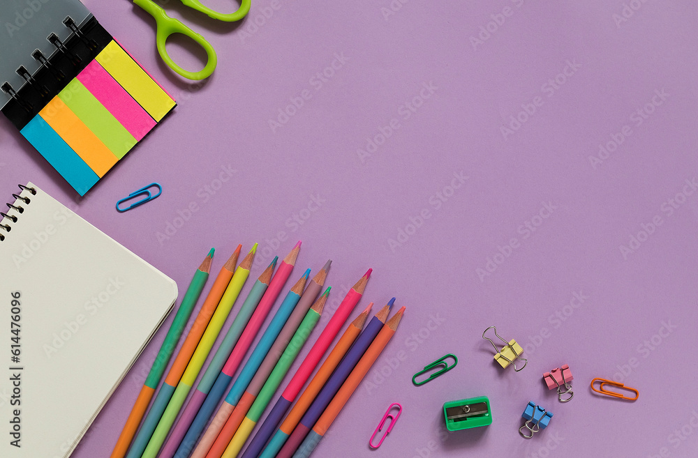 Fototapeta premium Bright modern school supplies on a purple background. Back to school concept. Top view. Copy space.