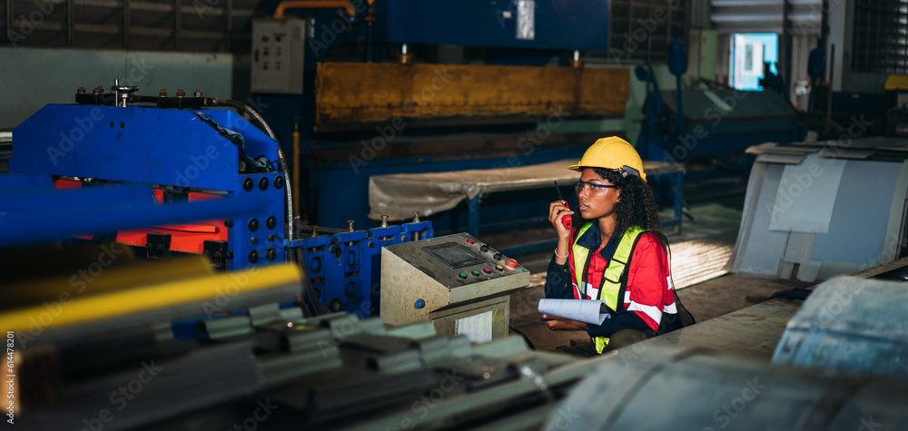Fototapeta premium Industrial worker inspecting and check up machine at factory machines.Technician working in metal sheet at industry. Foreman checking Material or Machine.
