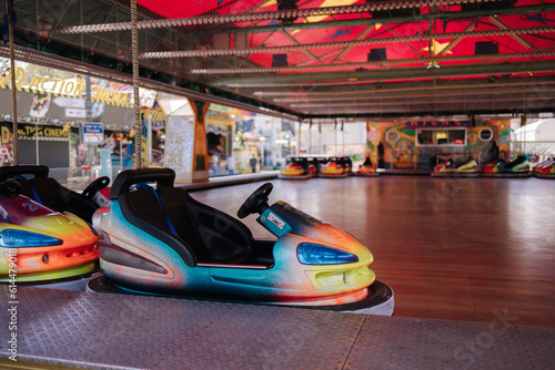 Bumper car at fun fair. Colorful electric cars in amusement park © Aleksandr