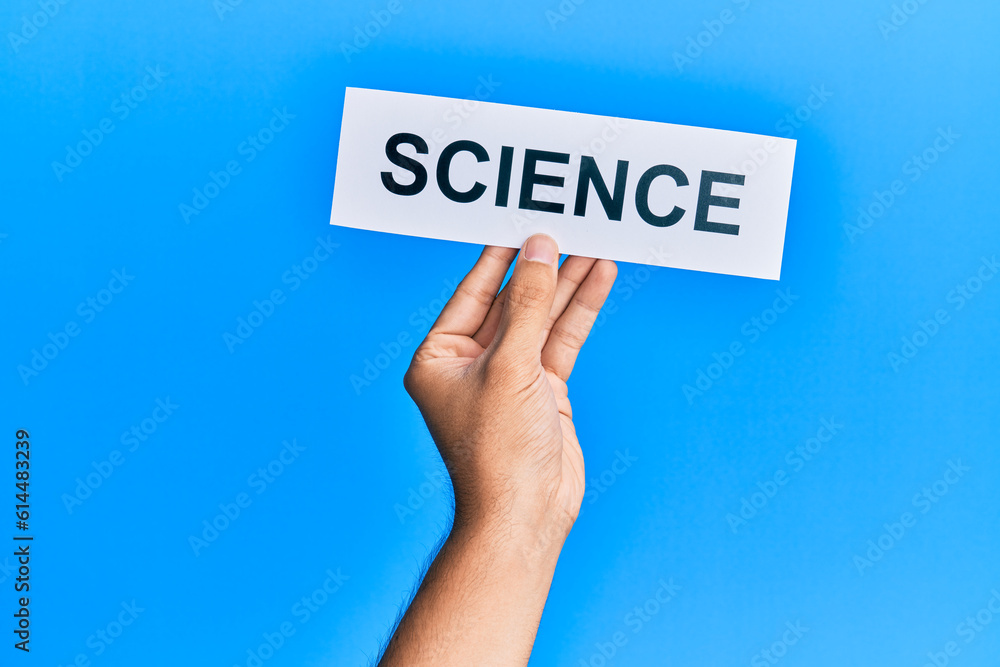 Hand of caucasian man holding paper with science word over isolated blue background Hand of caucasian man holding paper with science word over isolated blue background