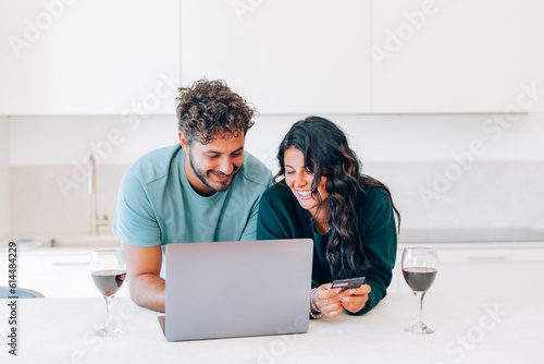Canvas Print couple surfing the internet making digital credit card purchases in the web