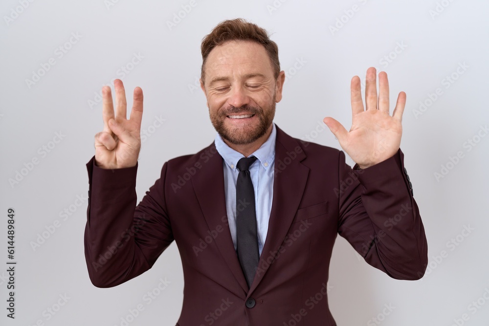 Middle age business man with beard wearing suit and tie showing and pointing up with fingers number eight while smiling confident and happy. Middle age business man with beard wearing suit and tie showing and pointing up with fingers number eight while smiling confident and happy.