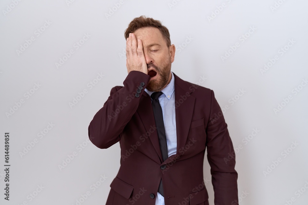 Middle age business man with beard wearing suit and tie yawning tired covering half face, eye and mouth with hand. face hurts in pain. Middle age business man with beard wearing suit and tie yawning tired covering half face, eye and mouth with hand. face hurts in pain.