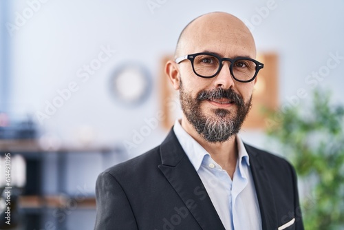 Young bald man business worker smiling confident at office