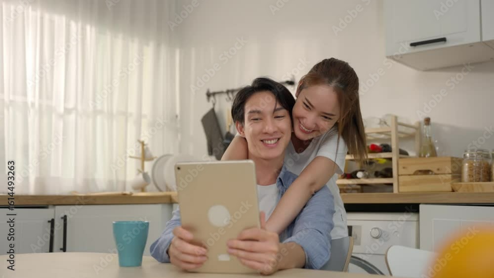A happy and loving Asian couple shares joyful moments in their home kitchen, radiating love and playfulness. With genuine smiles and a relaxed vibe, Couple enjoy their time together in Kitchen A happy and loving Asian couple shares joyful moments in their home kitchen, radiating love and playfulness. With genuine smiles and a relaxed vibe, Couple enjoy their time together in Kitchen