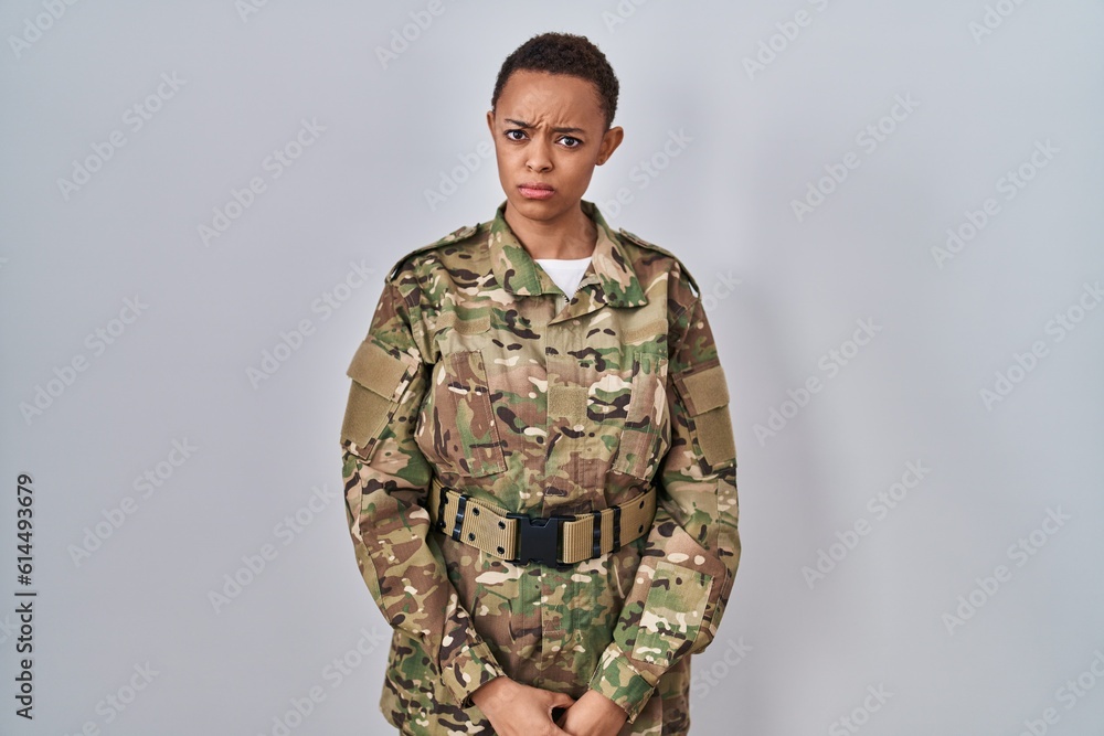 Beautiful african american woman wearing camouflage army uniform skeptic and nervous, frowning upset because of problem. negative person.