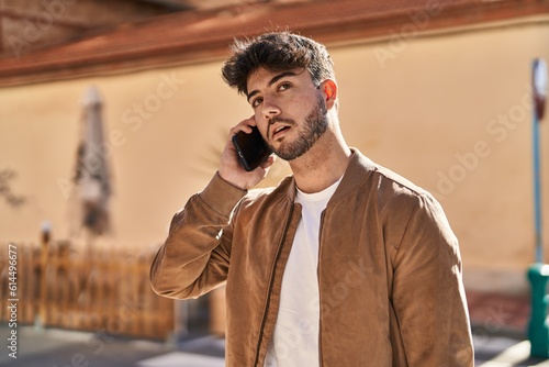 Young hispanic man talking on the smartphone at street © Krakenimages.com