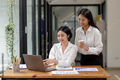 Shot of two business colleagues working in their office.