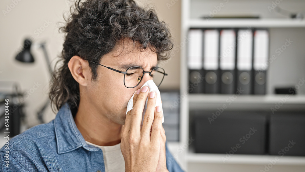 Young hispanic man business worker being sick using napkin at office Young hispanic man business worker being sick using napkin at office