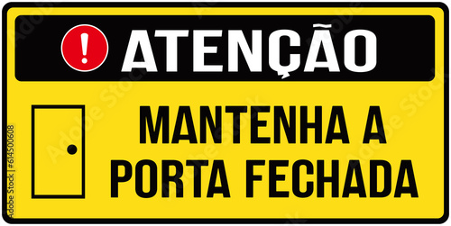 A sign that says in Portuguese language : attention, keep the door closed. photo