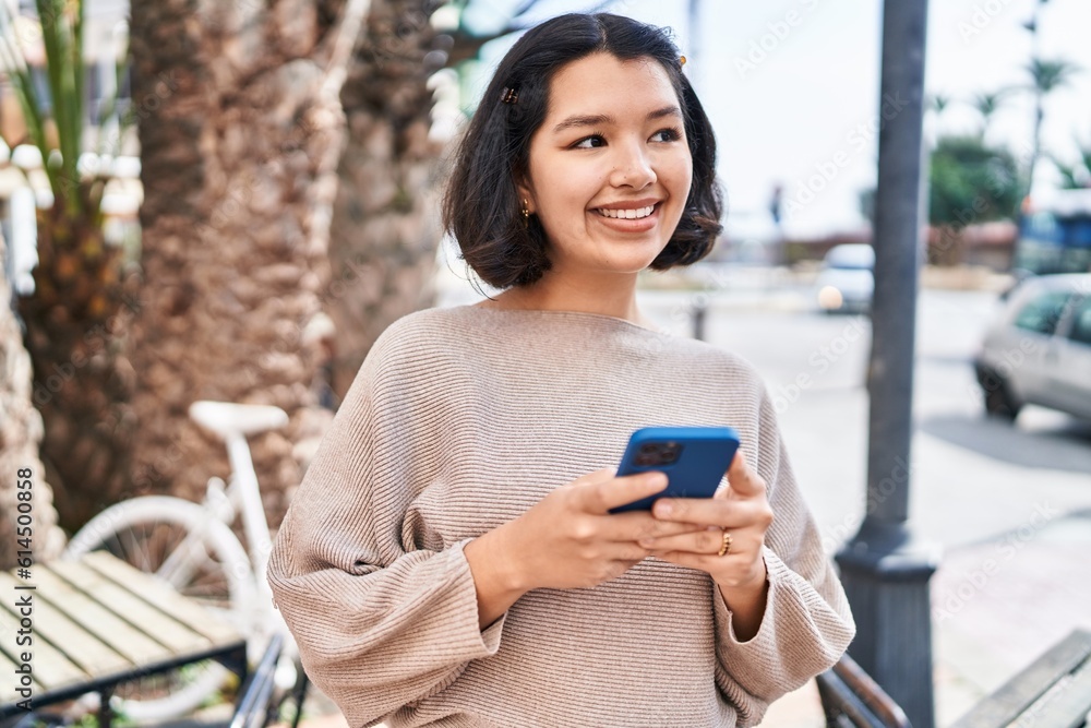 Young woman smiling confident using smartphone at street Young woman smiling confident using smartphone at street
